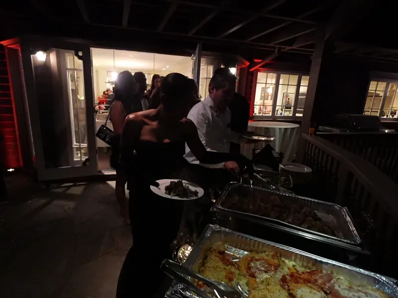 Guests toasting at a catered celebration in a clubhouse setting