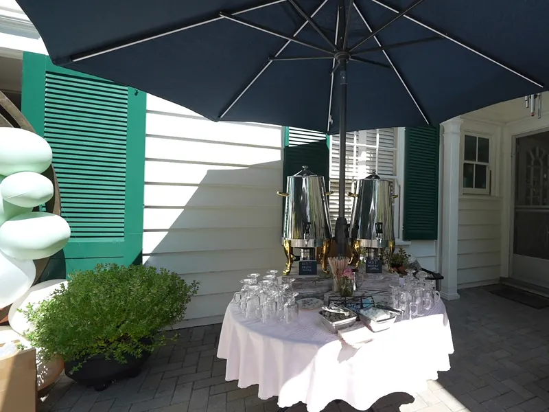 Servers passing appetizers to guests during cocktail hour at a home event