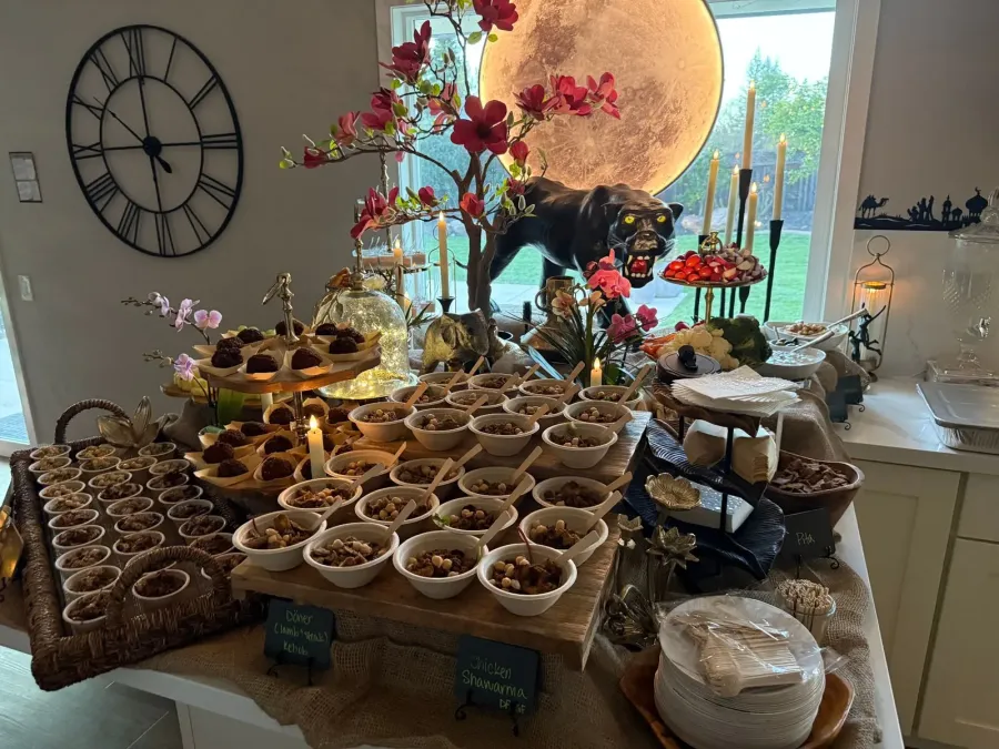 Mediterranean spread of grilled skewers, couscous salad, hummus and warm flatbread laid out for a Redwood City reception by Winslow's Catering Redwood City