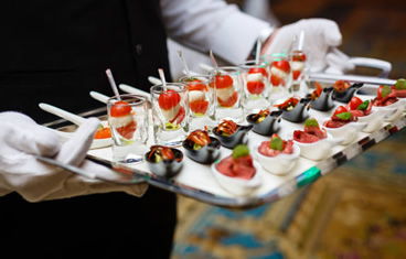 Waiter serving appetizers for vegetarian catering