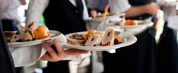Caterers serving food in a wedding catering family style dinner menu services in stanford